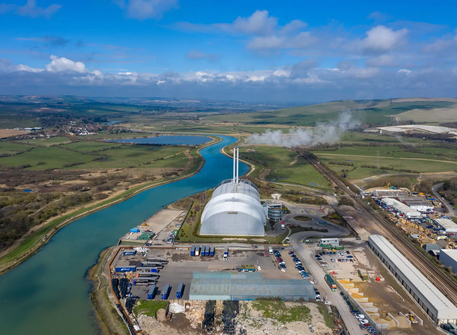 Drone view along a river estuary with new development