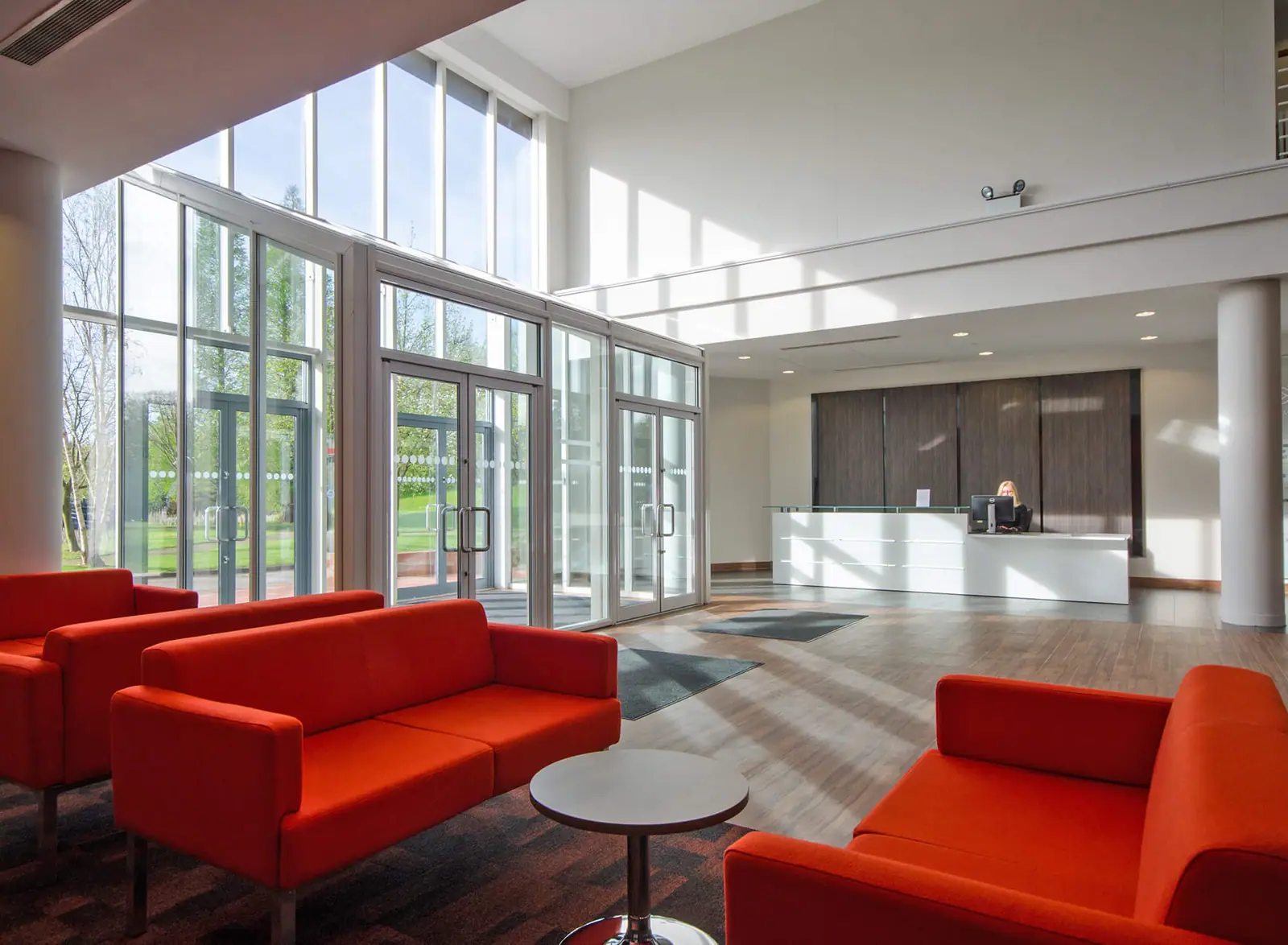 Office reception with red sofas