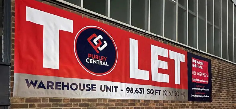Giant red 'to let' warehouse banner