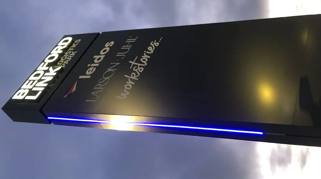 Illuminated Bedford estate sign at dusk