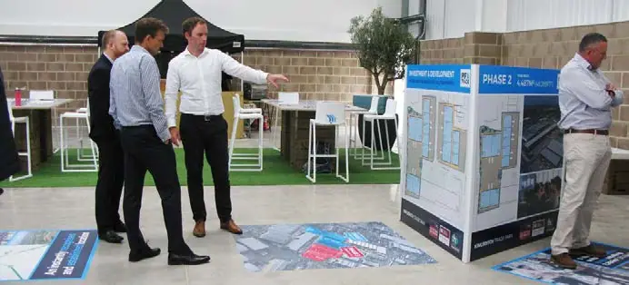 Agents viewing a marketing display at a launch