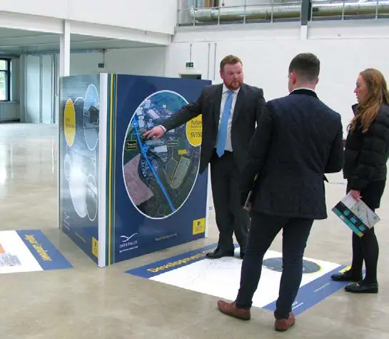 Agents with a printed marketing cube at a launch