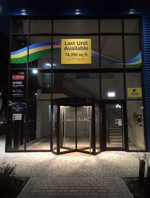 Night-time view of 'to let' window graphics