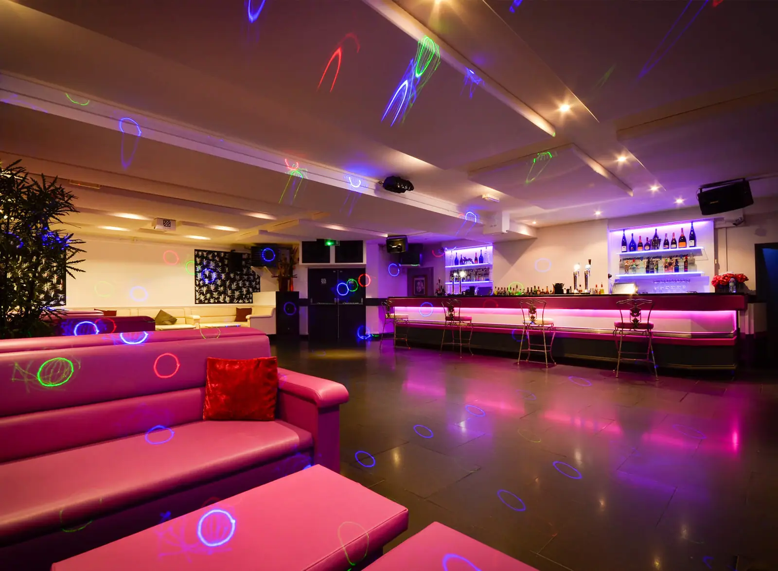 Basement nightclub dance floor under coloured lighting