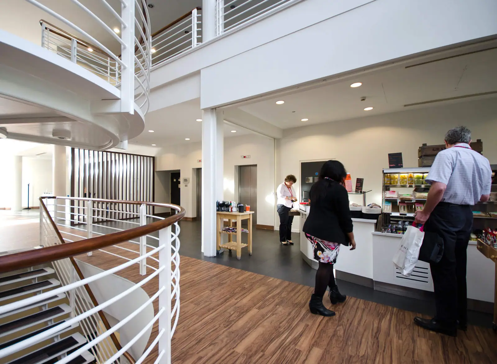 Office atrium with a coffee point and gallery walkway