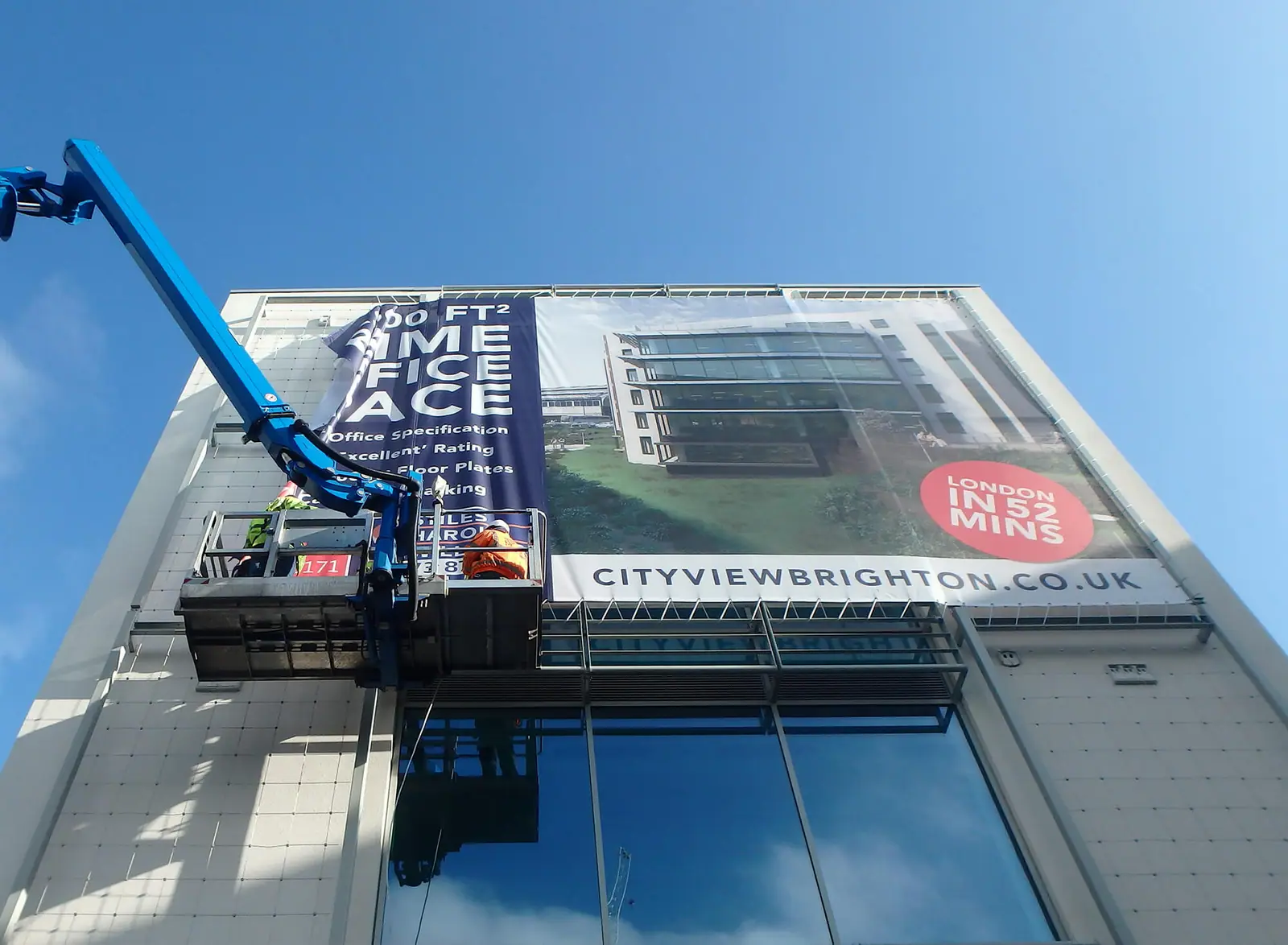 Cherry picker installing the 10-metre marketing banner on City View
