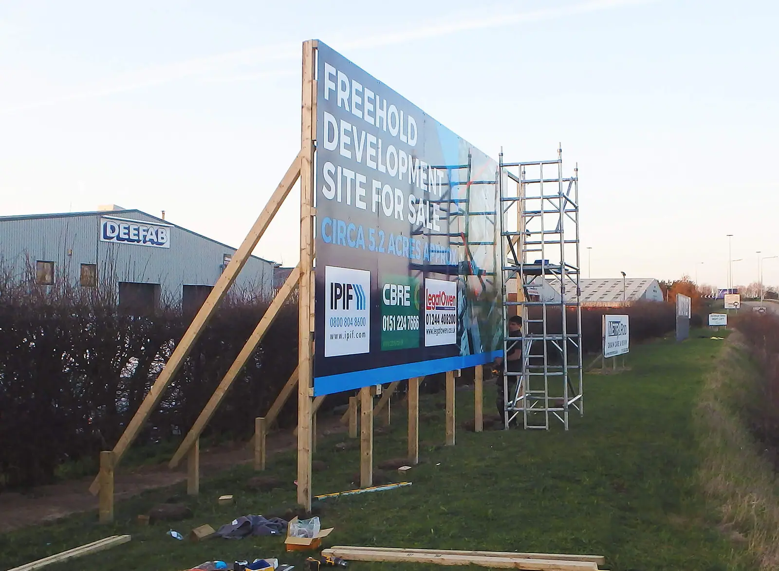 'Freehold development site' board going up on scaffolding at Deeside