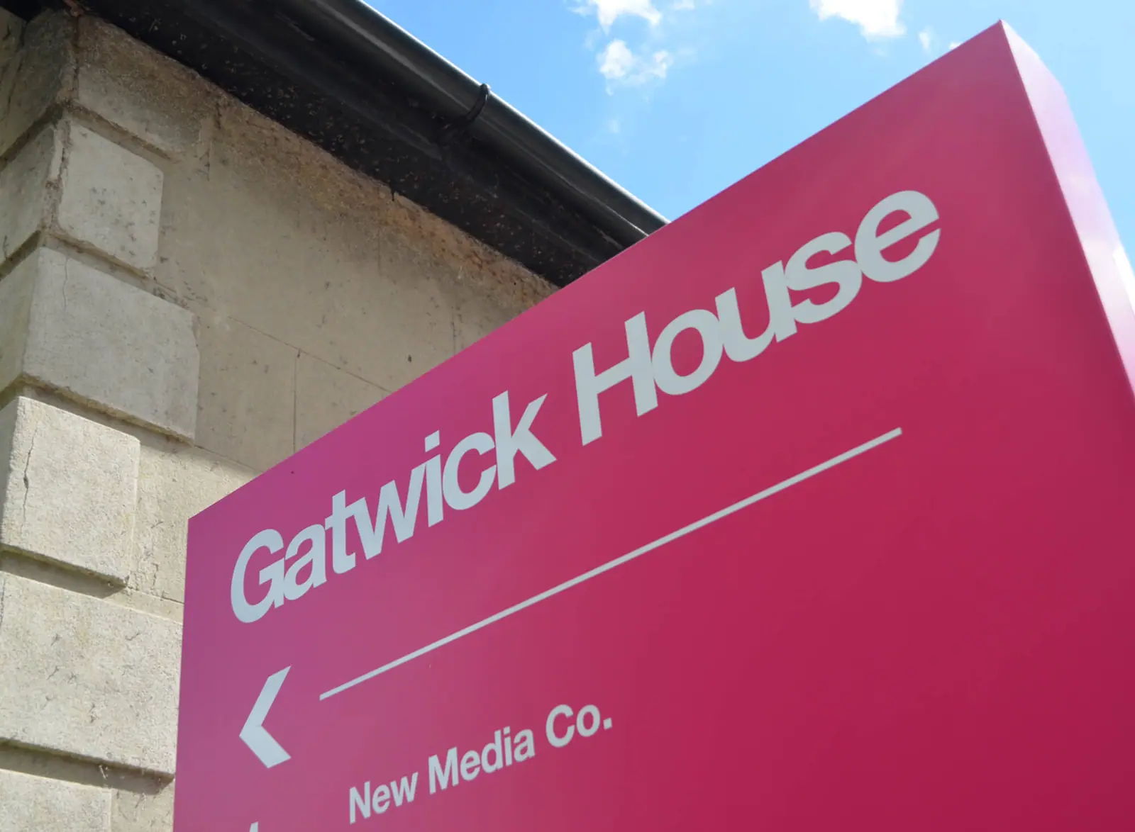 Gatwick House entrance sign with a directional arrow