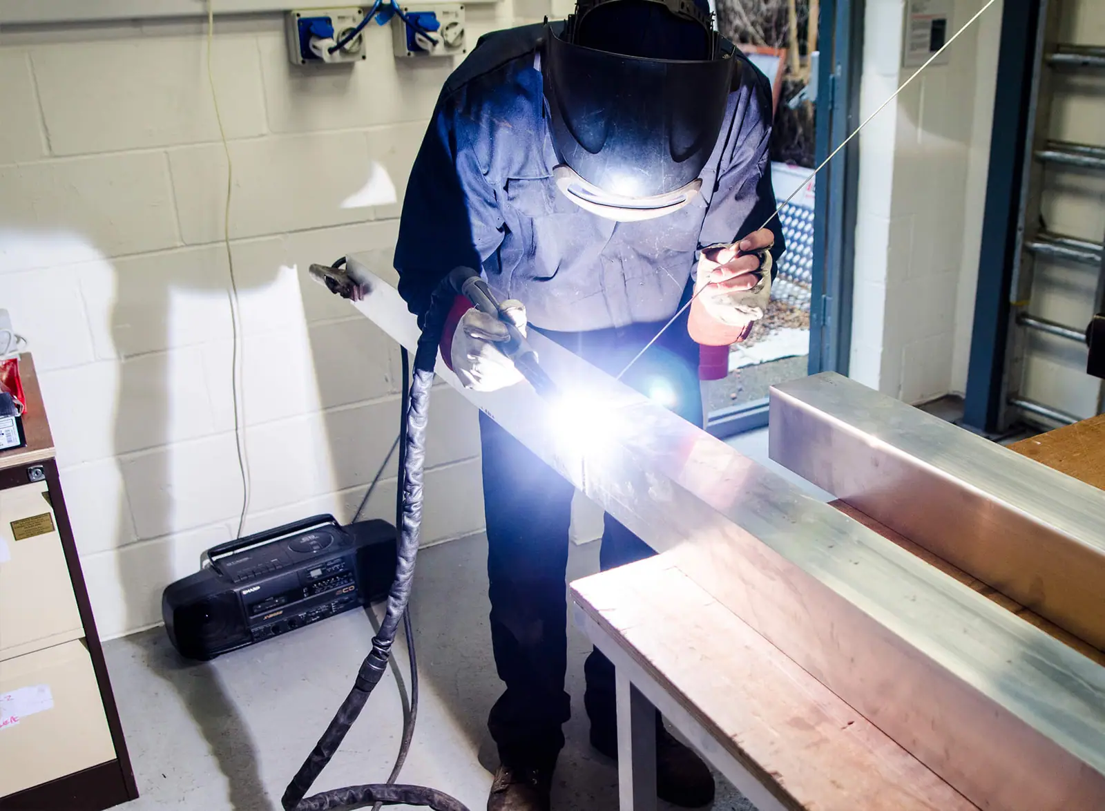Welding a sign frame in the Three Sixty workshop
