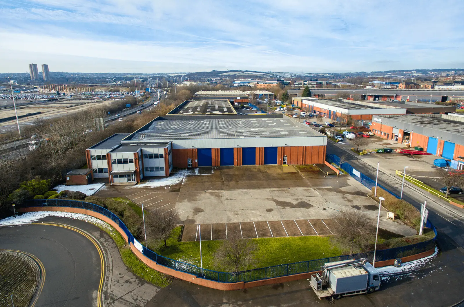 Aerial view of Latchmore Park with the Leeds skyline behind