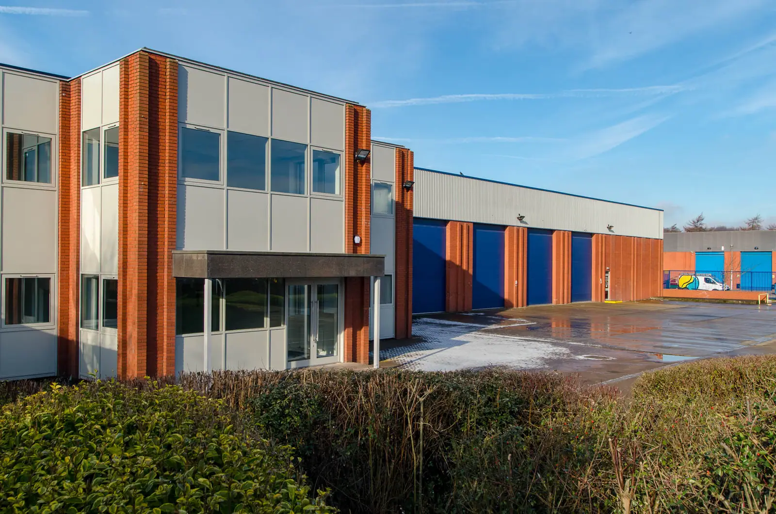 Latchmore Park unit exterior with orange cladding and blue doors