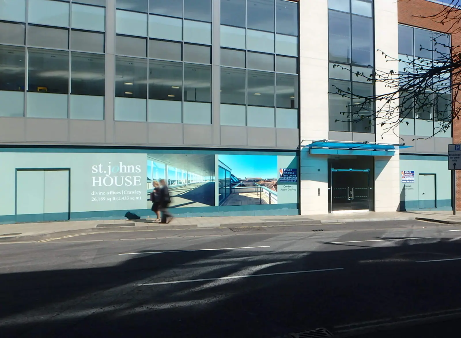 The full St Johns House frontage with hoarding graphics