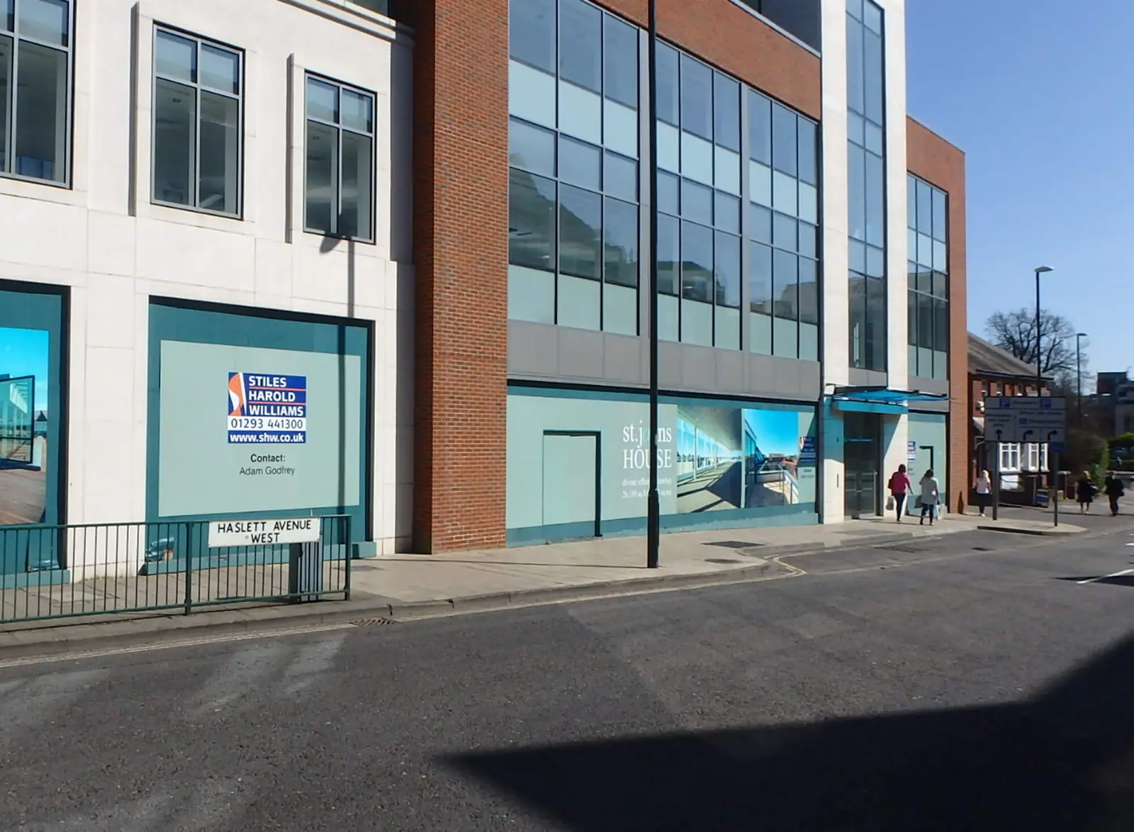 Street view of the building and hoarding