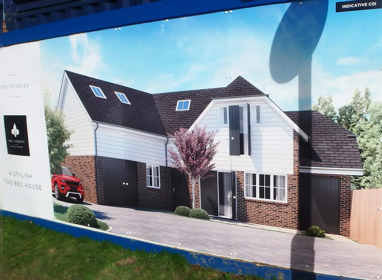 Hoarding panel showing a new house