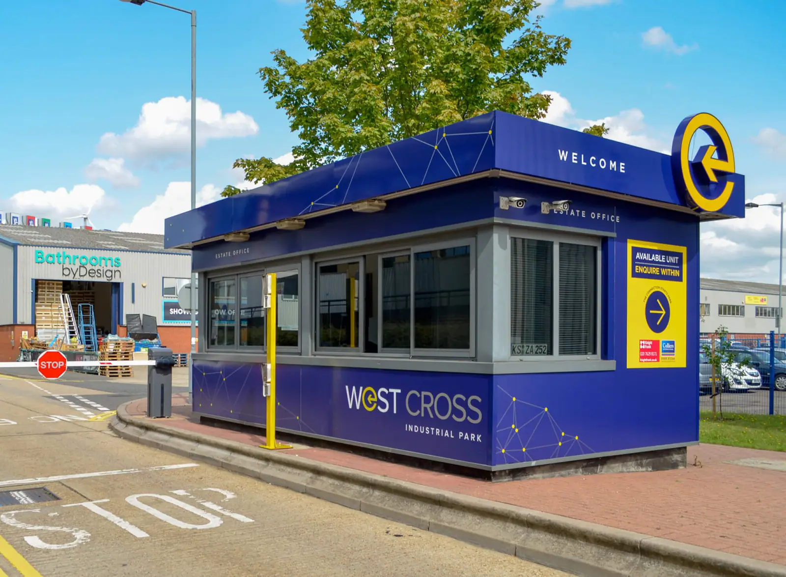 West Cross gatehouse wrapped in navy with the yellow 'e' symbol