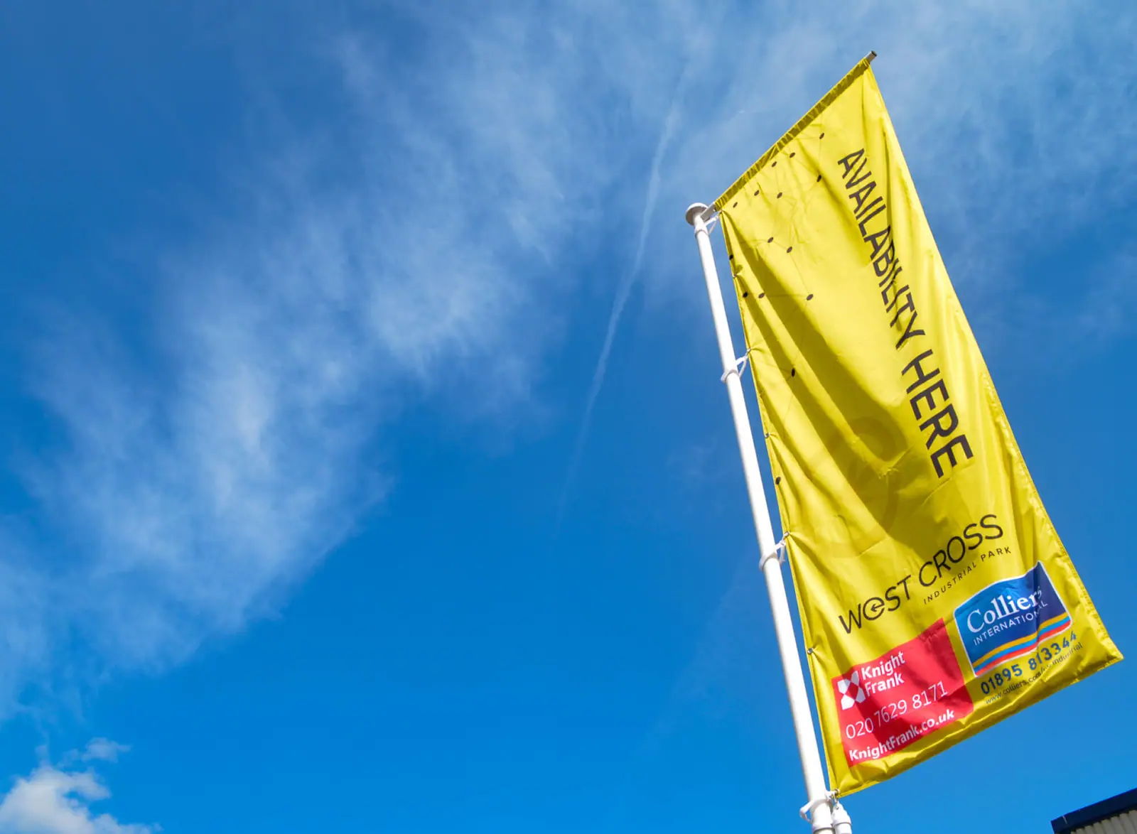 Yellow 'available here' flag against a blue sky