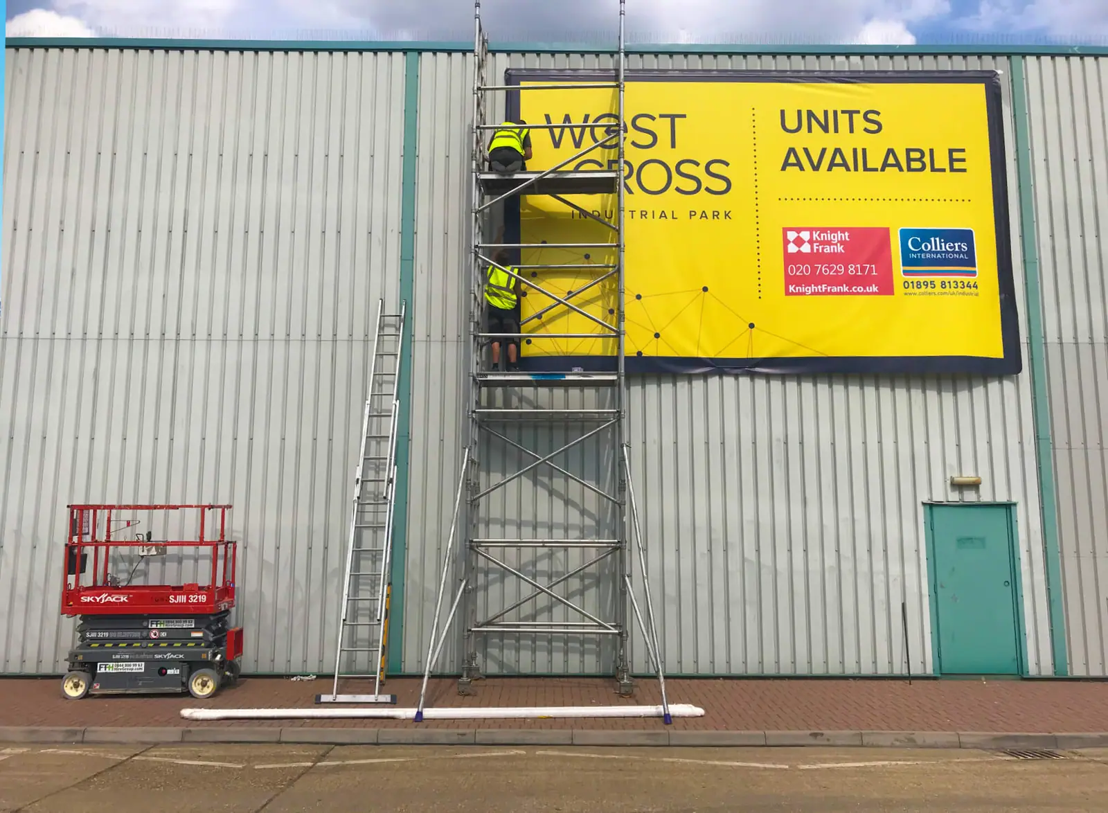 Installing a 'units available' banner from a scaffold tower